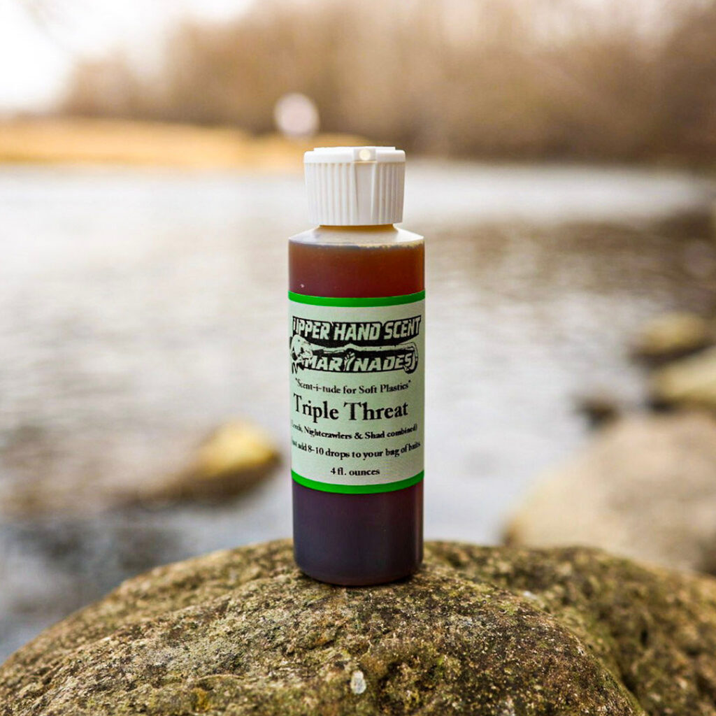 Bottle of Upper Hand Scents liquid fishing scent. Triple Threat